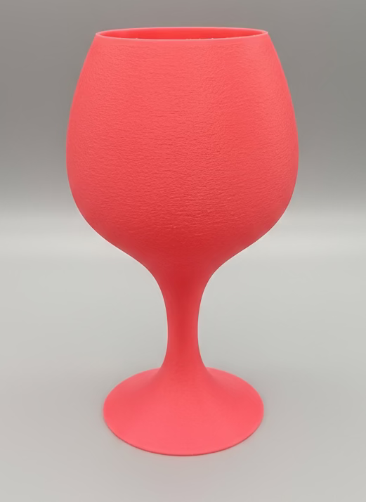 Pink wine glass on a black background