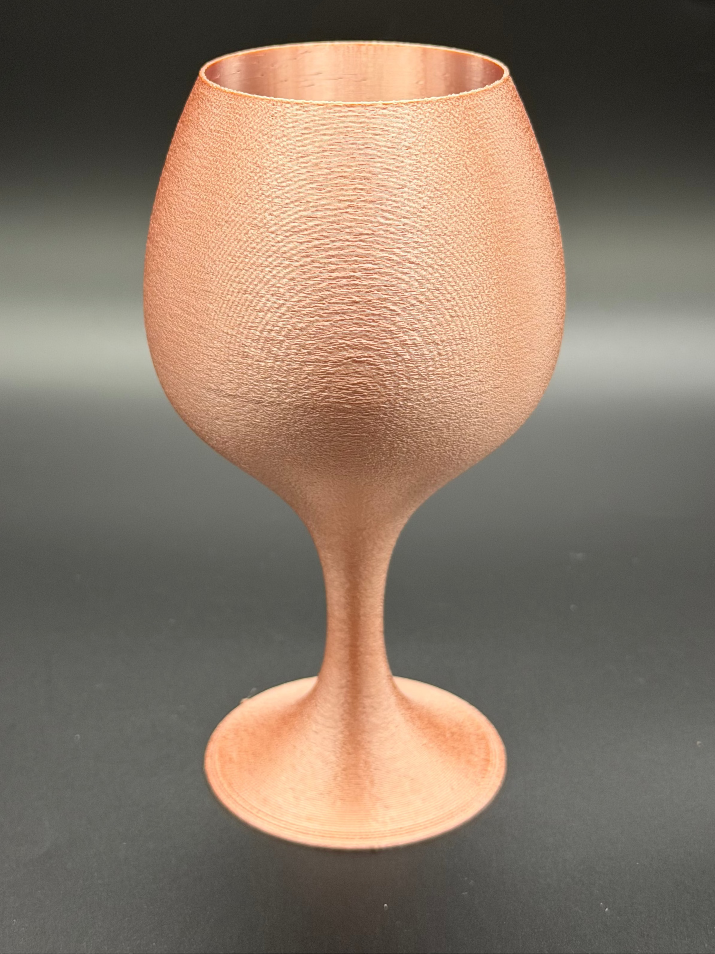 Rose Gold coloured goblet on a dark background
